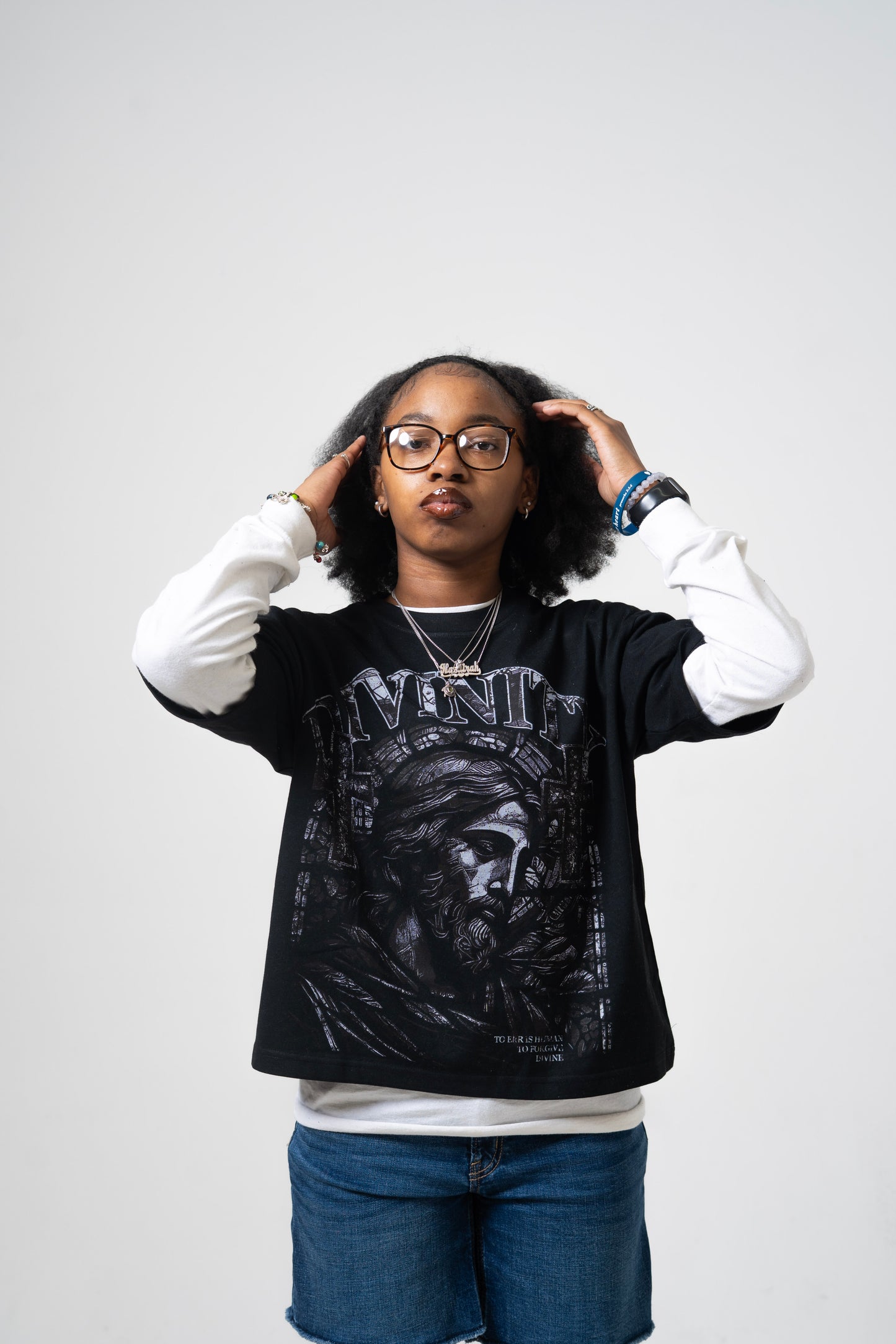 Model wearing the Divinity Crop Tee featuring 100% cotton DTG print on a black background.