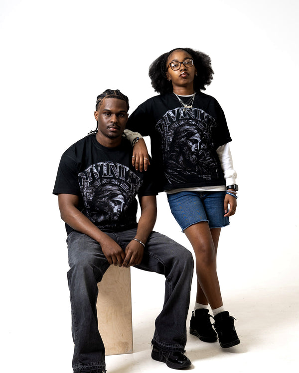 DIVINITY Grace Over Guilt Tee worn by two models — Romans 8:1, stained glass graphic tee